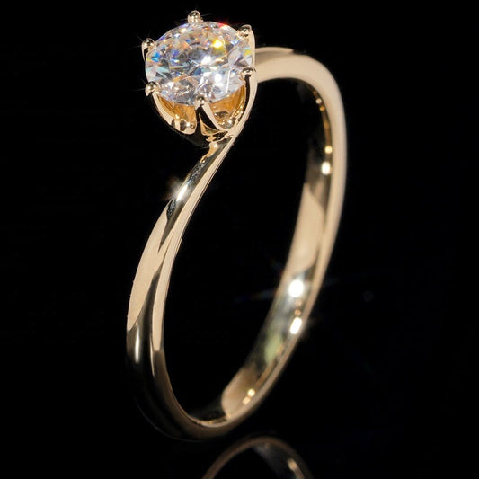 Gold ring with a diamond on a black background